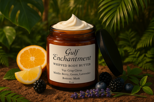 8 oz amber jar with body butter inside it.  Lid leaning against the jar.  Label in white that says, Gulf Enchantment Whipped Body Butter the fragrance notes are Top: Crisp Citrus; Middle: Berry, Green, Lavender; Bottom: Musk.  Include images that reflect the fragrance notes and the jar sitting in a lush tropical environment.